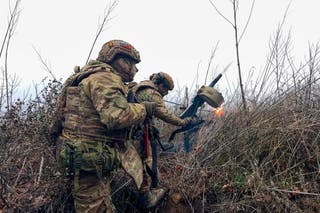 Russian soldiers fire a grenade launcher towards Ukrainian positions on an undisclosed location in Ukraine